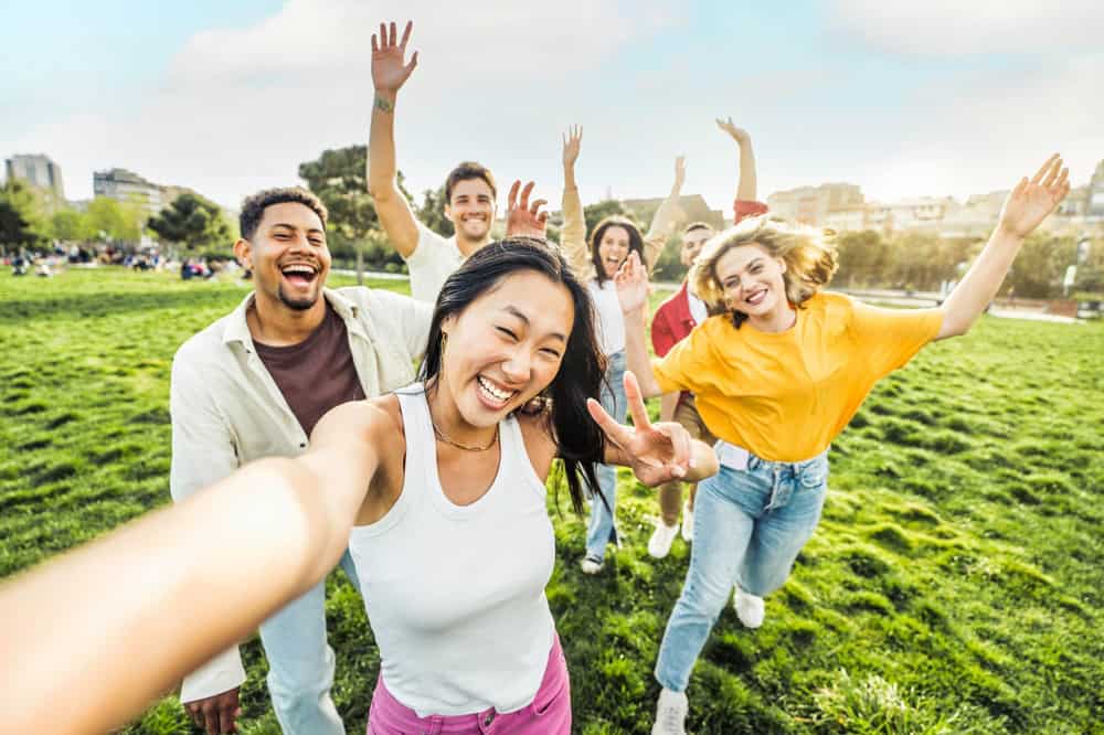 Group of friends taking a selfie at a park